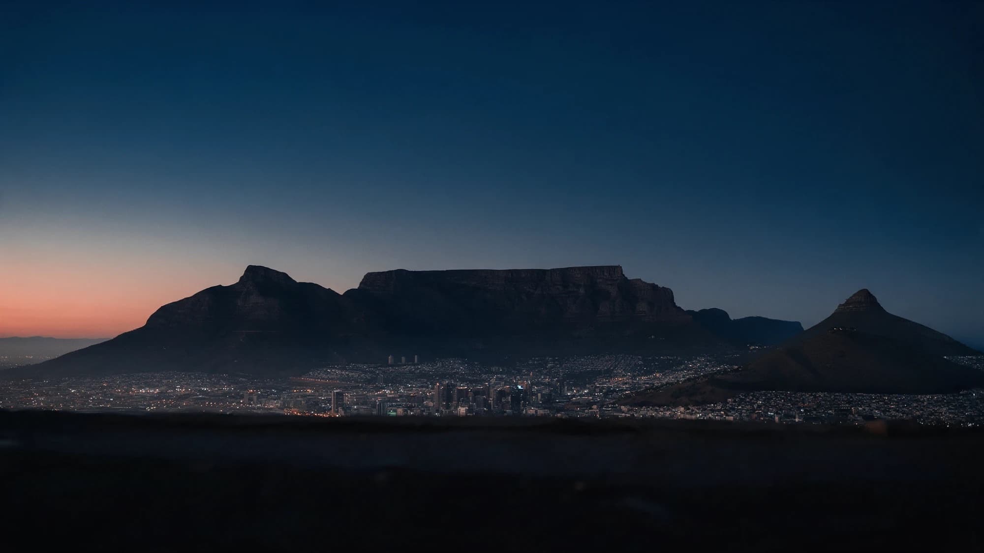 Table Mountain and the Cape Town city bowl at dusk, with Lion's Head on the right